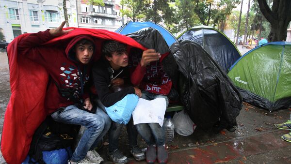 Izbeglice na kiši - Sputnik Srbija