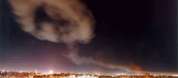 Smoke billows over the northern Yugoslav city of Novi Sad, some 70 kms. north of Belgrade after NATO air raids late Wednesday March 24, 1999. - Sputnik Srbija